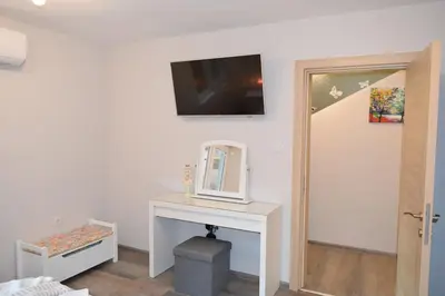 a room with a table with a mirror and a tv on the wall at SWEET HOME PLOVDIV in Plovdiv