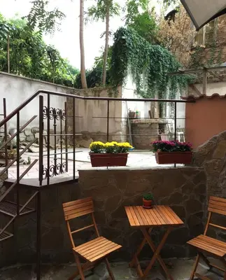 a patio with two chairs and two tables at SWEET HOME PLOVDIV in Plovdiv