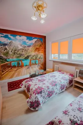 a bedroom with a large painting on the wall at Dimitrovi Rooms in Sofia