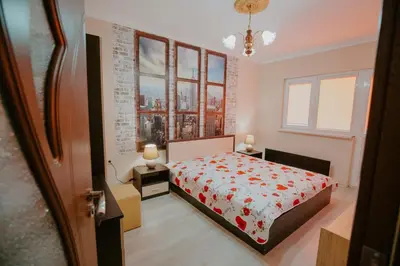 a bedroom with a bed and a view of a city at Dimitrovi Rooms in Sofia