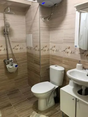 a bathroom with a toilet and a sink at Business sky Loft in Sofia