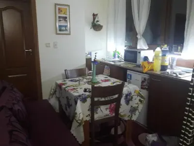 a kitchen with a table with a candle on it at Пампорово Студио М хотел в Росица in Pamporovo