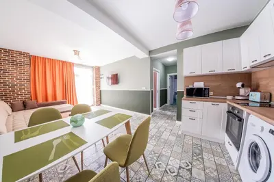 a kitchen and living room with a table and chairs at Sofia Rococo Life Apartments in Sofia