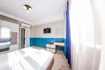 a bedroom with two beds and a blue wall at Sofia Rococo Life Apartments in Sofia