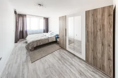 a bedroom with a bed and a large mirror at NEXT TO GONDOLA. Cosy & Elegant 2 Bedroom apartment in Neon Complex in Bansko