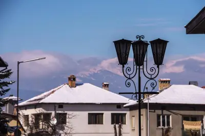 a street light with snow on top of a building at NEXT TO GONDOLA. Cosy & Elegant 2 Bedroom apartment in Neon Complex in Bansko