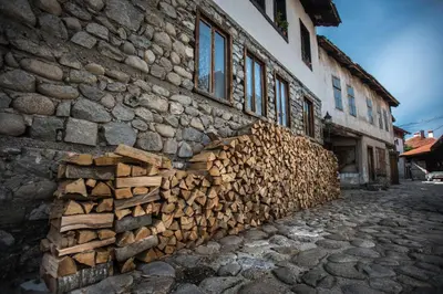 a pile of fire wood on the side of a building at NEXT TO GONDOLA. Cosy & Elegant 2 Bedroom apartment in Neon Complex in Bansko