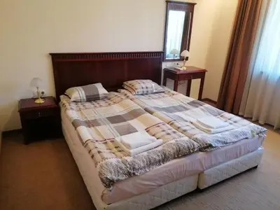 a bedroom with a large bed with two night stands at Downtown Luxury private apartments in Bansko