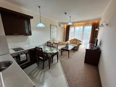 a kitchen and living room with a table and chairs at Downtown Luxury private apartments in Bansko