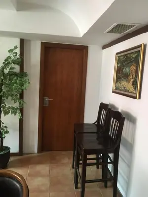 a table and chairs in a room with a door at Apartment 507 The Castle 1 in Pamporovo