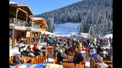 a large crowd of people sitting in chairs at a ski resort at Stylish Studio Apart Aspen Golf Resort in Razlog