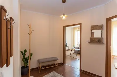 a hallway with a door leading to a living room at Charming Ski Apartments Near Gondola & Bar Street, Cedar Lodge 1 Complex in Bansko