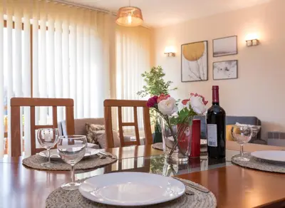 a dining room with a table with a bottle of wine at Charming Ski Apartments Near Gondola & Bar Street, Cedar Lodge 1 Complex in Bansko