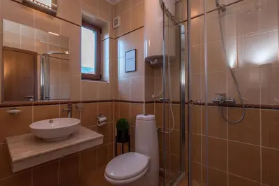 a bathroom with a toilet and a sink and a shower at Charming Ski Apartments Near Gondola & Bar Street, Cedar Lodge 1 Complex in Bansko