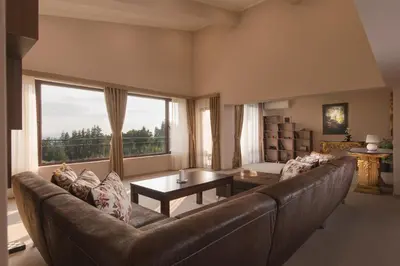 a living room with a couch and a large window at Hotel Villa Magus in Kladnitsa