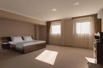 a hotel room with a bed and a window at Hotel Villa Magus in Kladnitsa