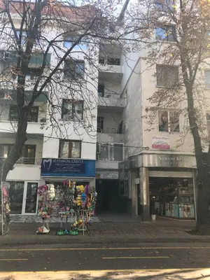 a building on a city street with a store at Аpartment Gem in Centre of Sandanski in Sandanski