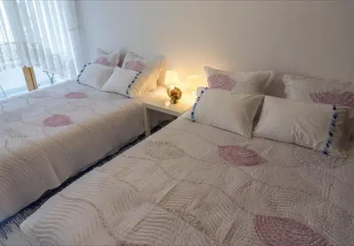 two beds sitting next to each other in a bedroom at Аpartment Gem in Centre of Sandanski in Sandanski
