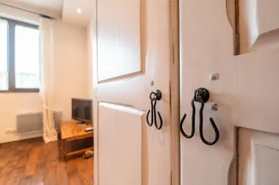 a white door with black handles in a room at Kings Park Boutique Apartment in Sofia