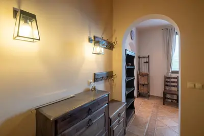 a hallway with an archway and a dresser in a room at Kings Park Boutique Apartment in Sofia