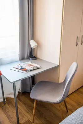a desk with a chair next to a window at City View Apartment With 2 Bedrooms and Free Garage in Blagoevgrad