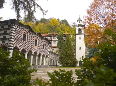 a building with a clock tower in a courtyard at City View Apartment With 2 Bedrooms and Free Garage in Blagoevgrad