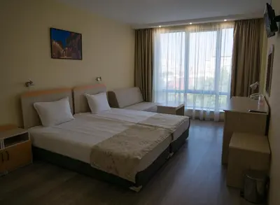 a hotel room with a bed and a window at Hotel Puldin COOP in Plovdiv