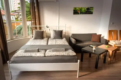 a bedroom with a bed and a couch at Studio Talisman II in Sofia