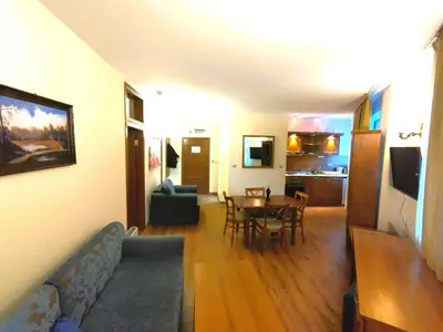 a living room with a couch and a table at Lucy's Apartments Emerald in Bansko