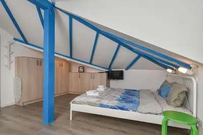 a bedroom with a bed with a blue canopy at The Ivy House - A Cozy Attic near the City Center by Flat Mаnager in Sofia