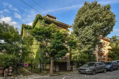 a building with a car parked in front of it at The Ivy House - A Cozy Attic near the City Center by Flat Mаnager in Sofia