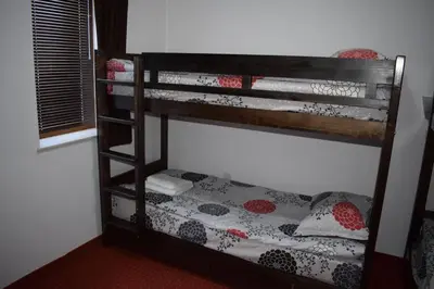 a bunk bed in a room with a bed sidx sidx sidx sidx at Private apartment in Prespa in Bansko
