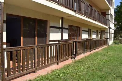 a balcony of a building with wooden railing at Private apartment in Prespa in Bansko