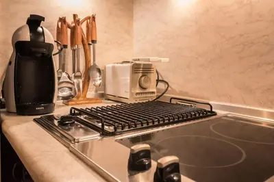a stove top with a toaster on top of a counter at Charming, Fully-furnished, 2-bedroom apartment by Flat Mаnager in Bansko