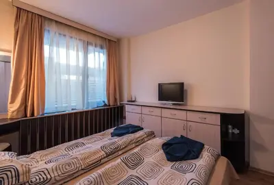 a hotel room with two beds and a television at Charming, Fully-furnished, 2-bedroom apartment by Flat Mаnager in Bansko
