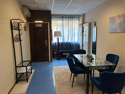 a waiting room with a table and chairs and a door at KCT Downtown Apartment in Sofia