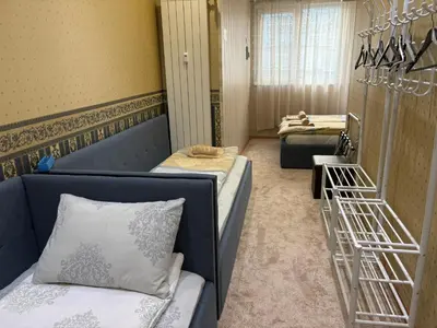 a small room with two beds and a staircase at KCT Downtown Apartment in Sofia