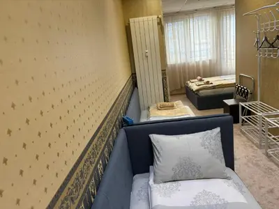 a room with a couch and two beds in it at KCT Downtown Apartment in Sofia