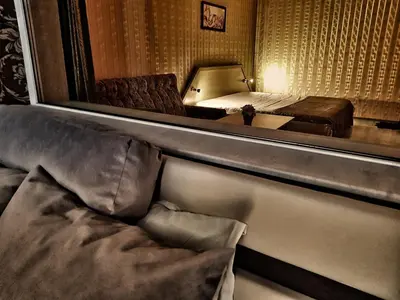 a bedroom with a bed and a mirror in a room at Discret Hotel & Restaurant in Vladaya
