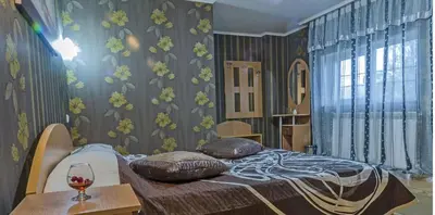 a bedroom with a bed with two pillows on it at Discret Hotel & Restaurant in Vladaya
