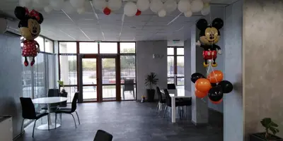 a room with a table and balloons on the ceiling at Семеен Хотел Дани in Asenovgrad