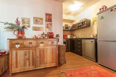 a kitchen with wooden cabinets and a refrigerator at Bansko Royal 721 Apartment in Bansko