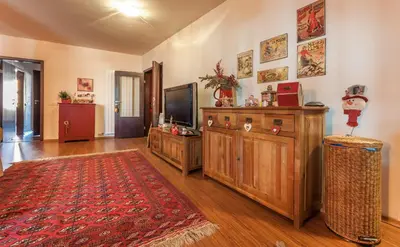 a living room with a television and a red rug at Bansko Royal 721 Apartment in Bansko