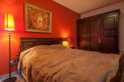 a bedroom with a bed and a painting on the wall at Bansko Royal 721 Apartment in Bansko