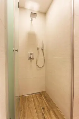 a bathroom with a shower with a glass door at SCA Sofia City Apartments in Sofia