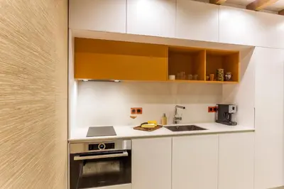a kitchen with white cabinets and a sink at SCA Sofia City Apartments in Sofia