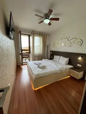 a bedroom with a bed and a ceiling fan at Apartment in Belvedere Holiday Club 550 m from ski lift in Bansko