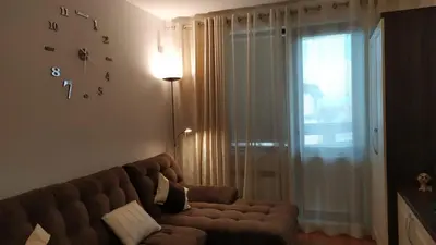 a living room with a brown couch and a window at Apartment in Belvedere Holiday Club 550 m from ski lift in Bansko
