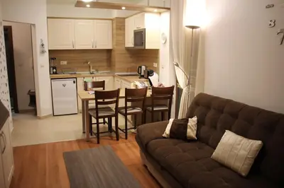 a living room with a couch and a kitchen at Apartment in Belvedere Holiday Club 550 m from ski lift in Bansko