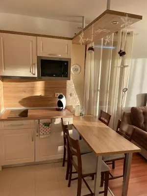 a kitchen with a wooden table and a dining room at Apartment in Belvedere Holiday Club 550 m from ski lift in Bansko